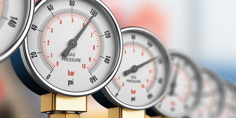 Oil and gas fuel manufacturing industry concept: 3D render illustration of row of metal steel high pressure gauge meters or manometers on tubing pipeline at LNG or LPG distribution station facility